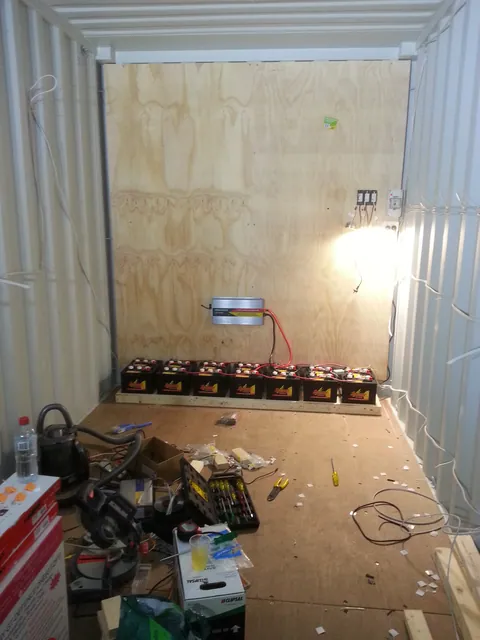 The early power installation and tools inside the unlined container.