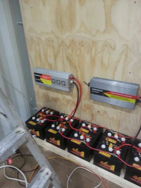 The battery bank beneath the wall-mounted power equipment.