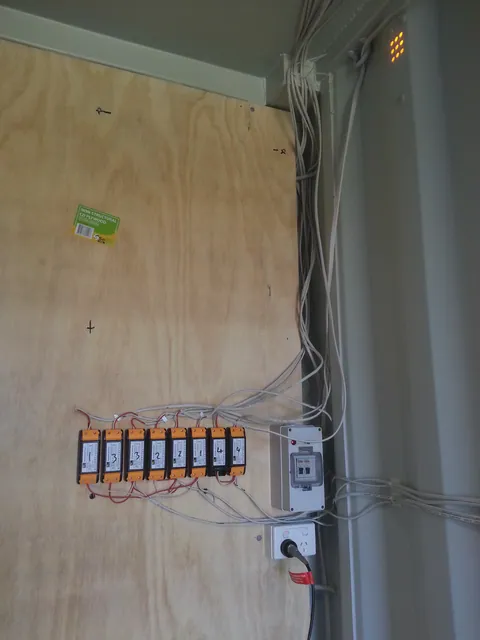 The numbered equipment mounted high on the plywood wall.
