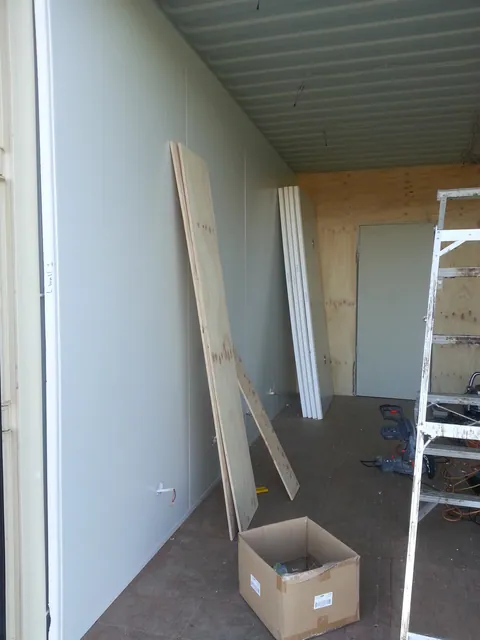 The first large wall lining panels in position.