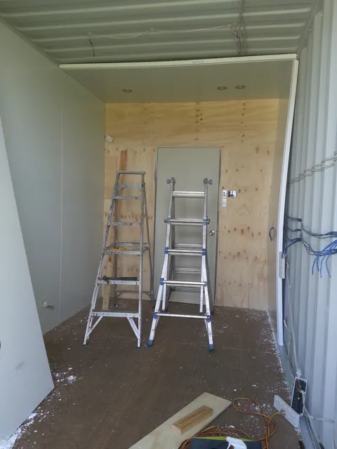 Wall lining progresses along both sides.