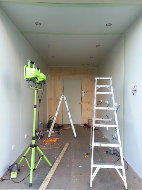The ceiling lined, with work lights and ladders still in place.
