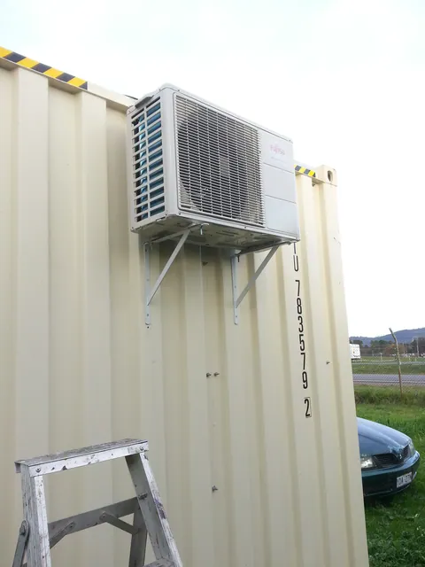 The air-conditioner outdoor unit mounted on the container.