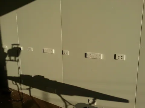 The row of power and data outlets along the workshop wall.