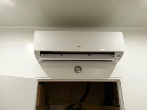 The indoor air-conditioning unit fitted above the service-area door.