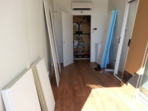 Cabinet panels and door components brought into the room.