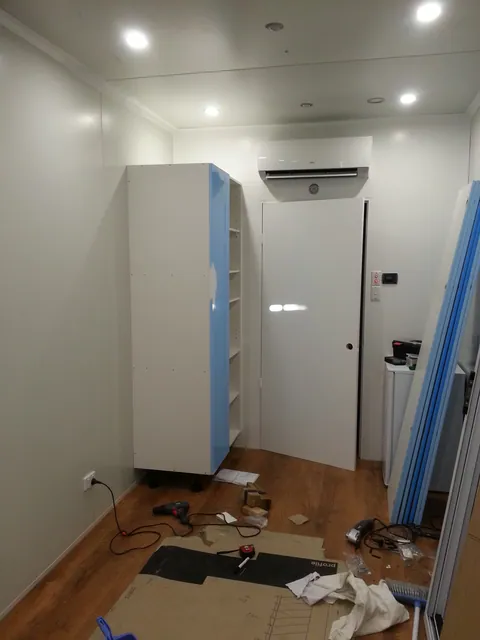 The first tall cabinet positioned against the wall.