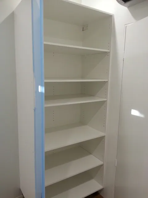 Shelving installed inside the tall cabinet.