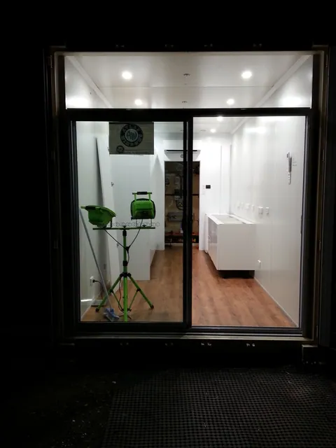 The new glazed entrance viewed from outside at night.
