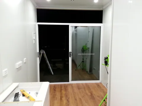 A wider interior view of the new sliding entrance.