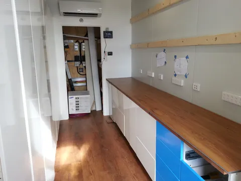 The long bench with parts storage at the entrance.