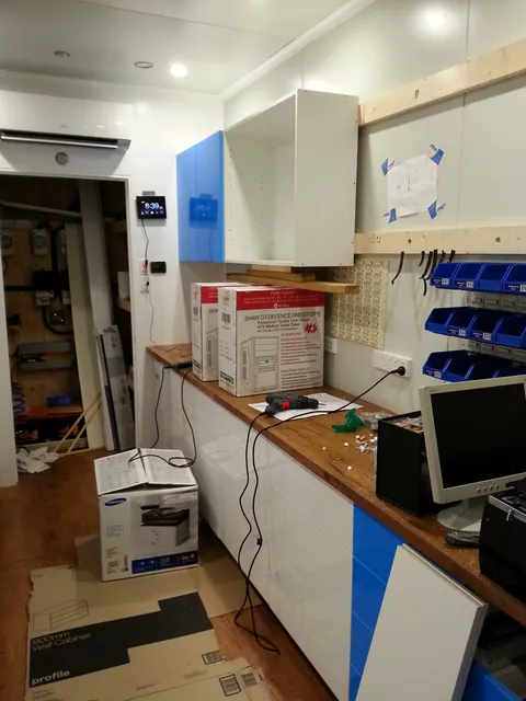 Further upper cabinets added along the wall.