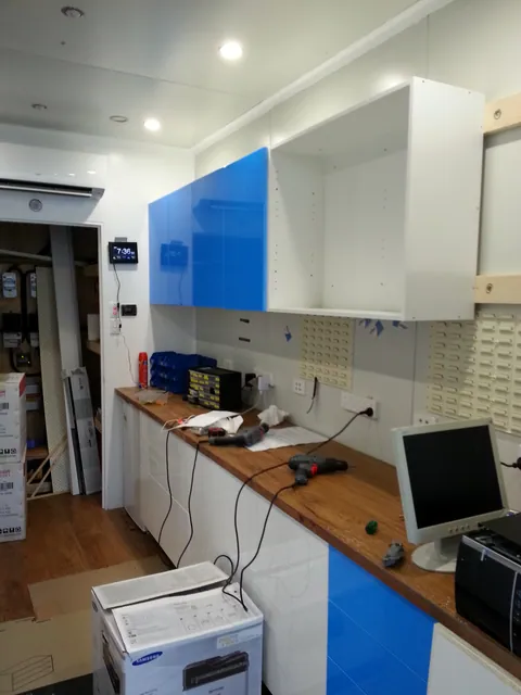 Upper cupboards installed with protective film still on the fronts.