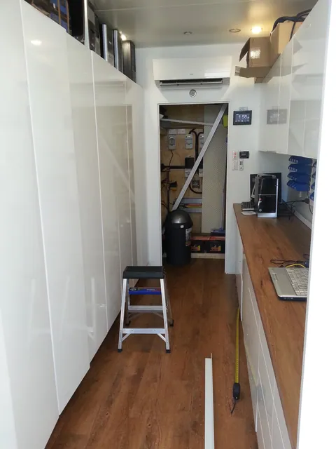 The clear aisle between storage cupboards and the repair bench.