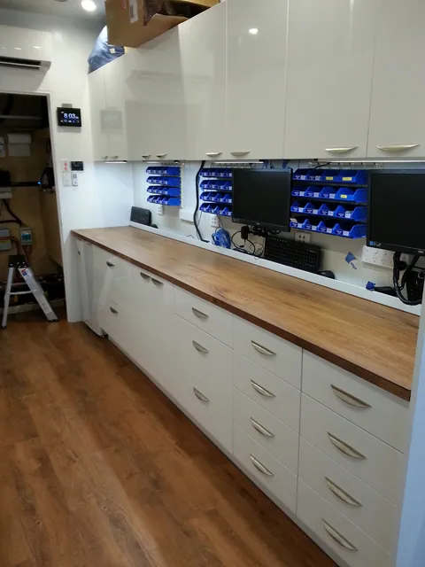 The finished first workshop, from storage cupboards to repair stations.