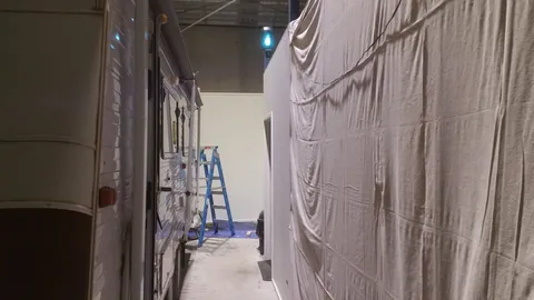 A narrow passage runs alongside the partly enclosed work area.