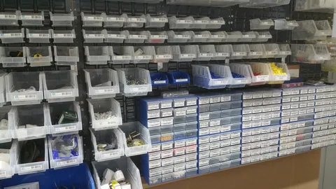 Rows of parts bins show how the existing workshop was organised.
