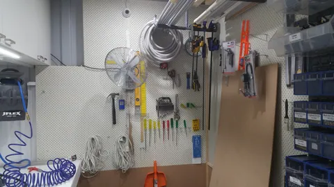 Tools and supplies fill the end of the repair bench.