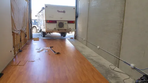 A timber floor and bare wall record the space before more fitting out.