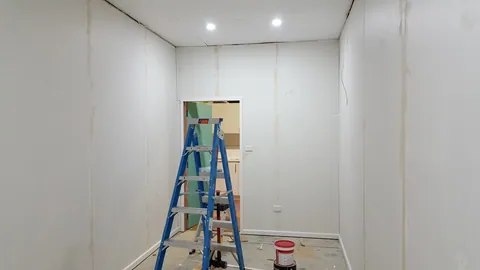 Joints and trim remain visible before painting.