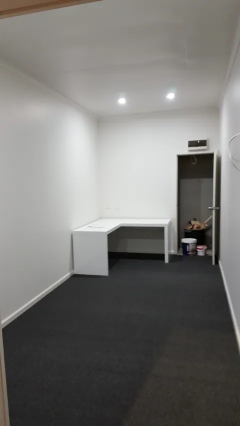 A desk goes into the far end of the room.