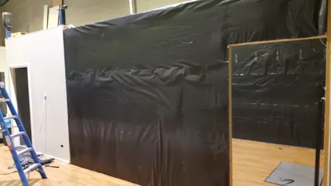 Black membrane encloses more of the retail corner.