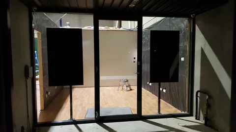 A view through the entrance glass shows the work still underway inside.