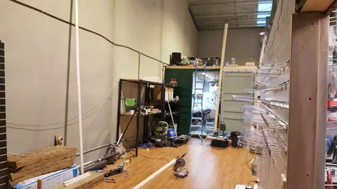 A bare wall records the next section before its new frame is installed.