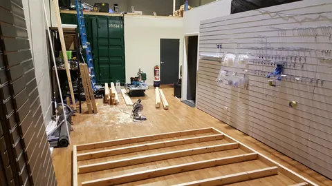 A rectangular timber frame is assembled flat on the floor.