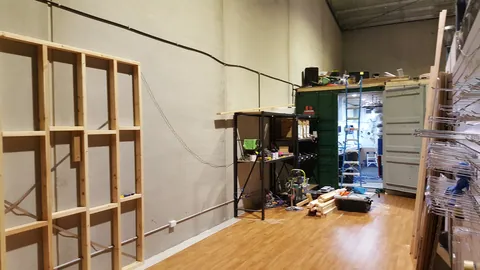 The frame is raised into position against the wall.