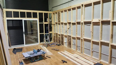 Horizontal timber members are added between the wall studs.