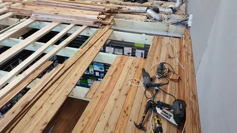 Timber boards start covering the ceiling structure.