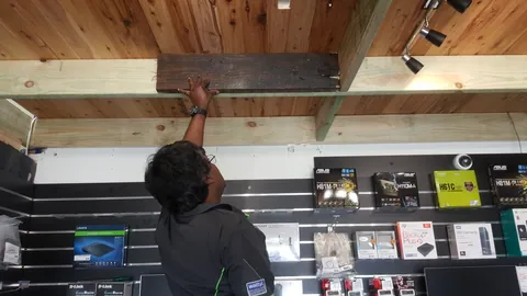 A beam is painted beneath the finished timber lining.