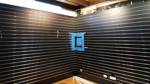 The panel area is masked while the surrounding finish is completed.
