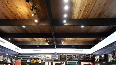A close view records the completed timber ceiling and lights.