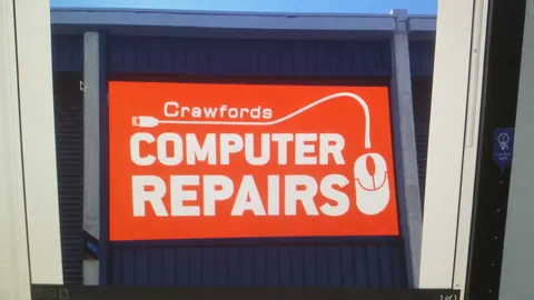 The orange Computer Repairs sign appears in the photographic record in May.