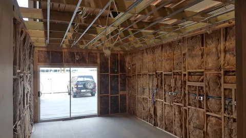 The next workshop phase begins with insulation and services still exposed.