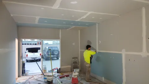 Joint finishing begins between the wall sheets.