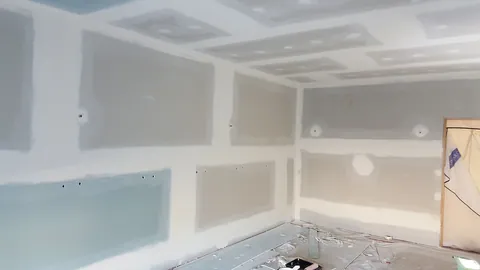 The filled joints and doorway edges are prepared for painting.