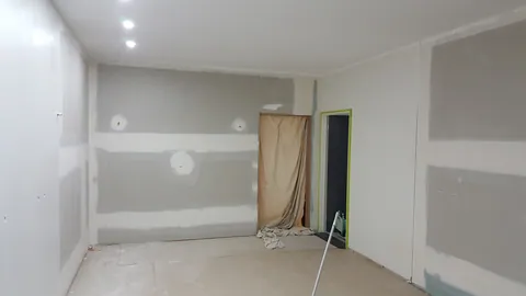 The reverse view shows paintwork still progressing around the room.