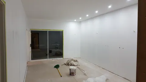 The room is now largely white, with services still to be finished.