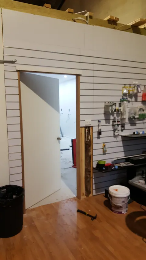 The workshop entrance is seen from the adjoining retail area.