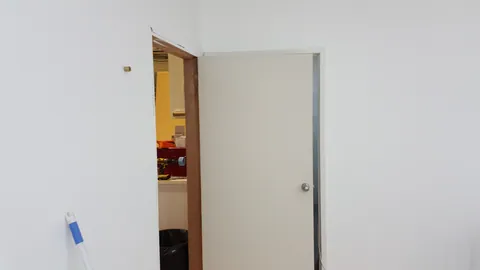 The painted door is fitted in place.