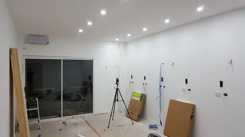 Air hoses and wall fittings begin equipping the empty room.