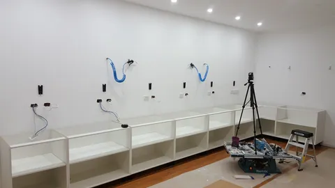 Cabinet bases now run along the workshop wall.