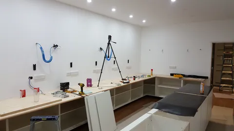 Dark benchtop sections are fitted to the island.