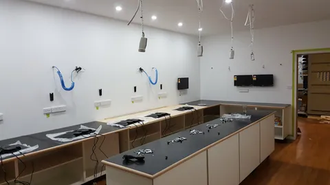 Wiring and equipment begin filling the bench stations.