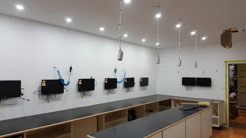 Hanging leads and fitted benches complete the main workshop layout.