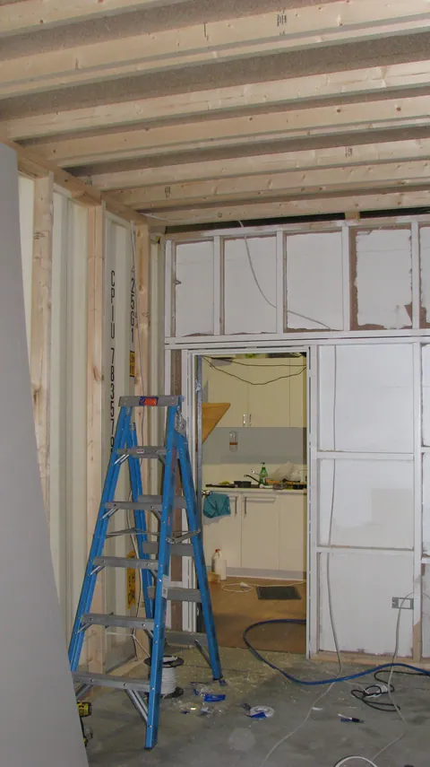 The doorway and wiring are visible during the lining work.