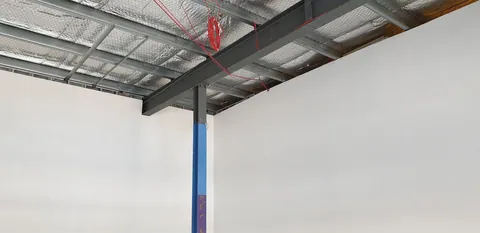The existing roof structure above the blue front column.